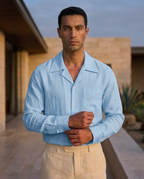Cuban Linen Shirt in sky blue — folded stack with RAFEEA label