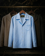 Cuban Linen Shirt in sky blue — hanging on rack